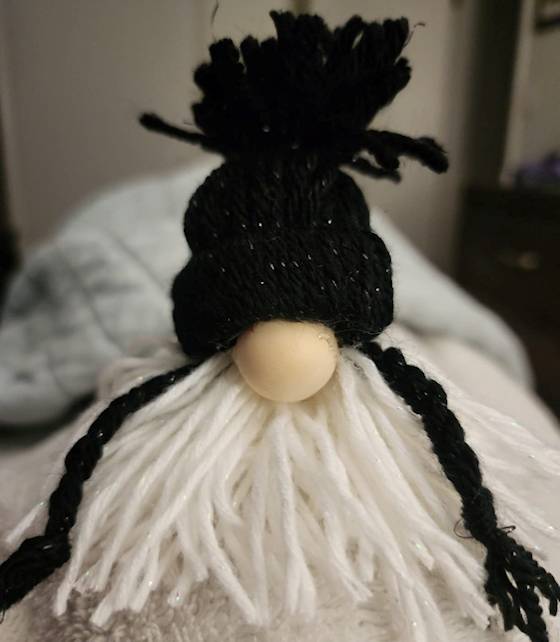 Gnome figure showing a 3 4 wooden ball as a nose